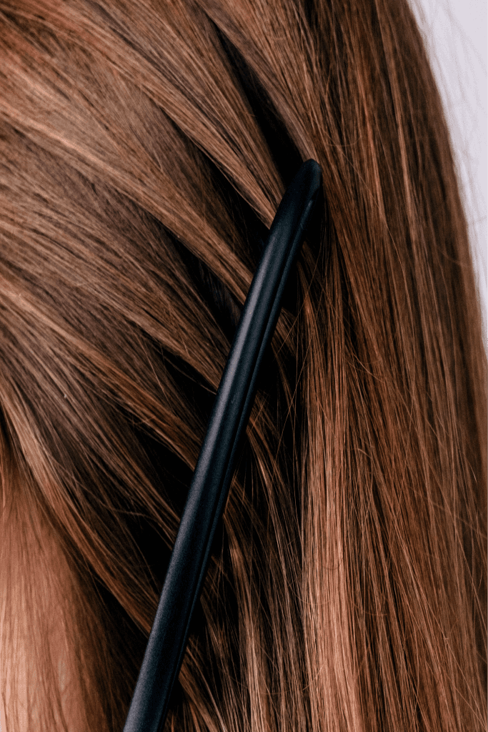 Close-up of a man's hair being combed