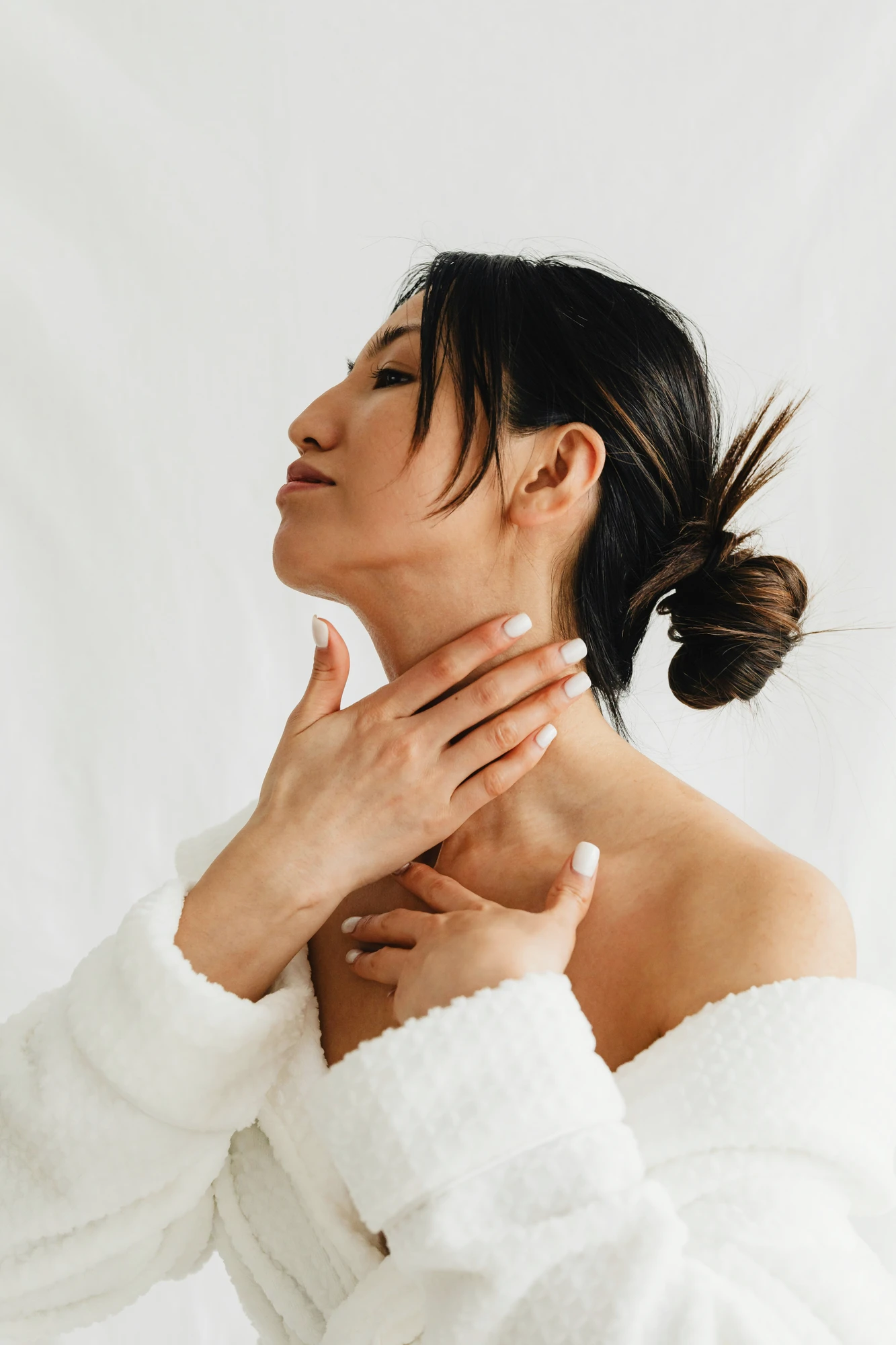 Woman applying skincare to her neck